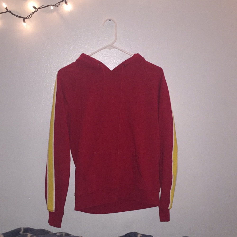 red hoodie w/ white & yellow stripes on the sleeve